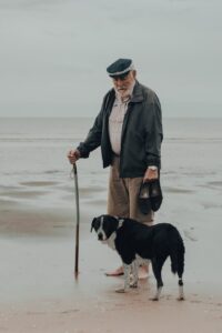old man and his dog at the sea shore