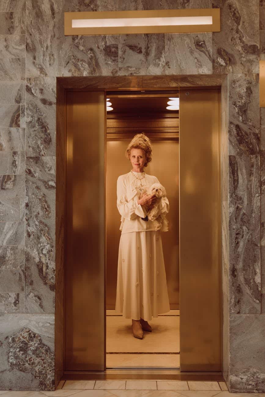 Woman in an elevator with her fur baby