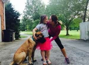 Unveiling the Power of Play: 5 Vital Benefits for Your Canine Companion Mother, daughter and mastiff at play