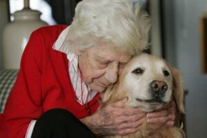 elderly woman hugging her dog
